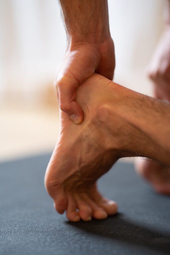 man holding his heel because of pain close up ve 2025 02 09 02 02 19 utc converted